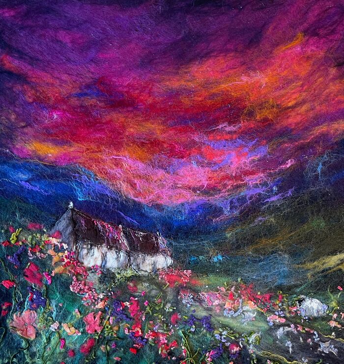 Colorful fiber artwork of a vivid landscape with a cottage and flowers, created by Moy Mackay.