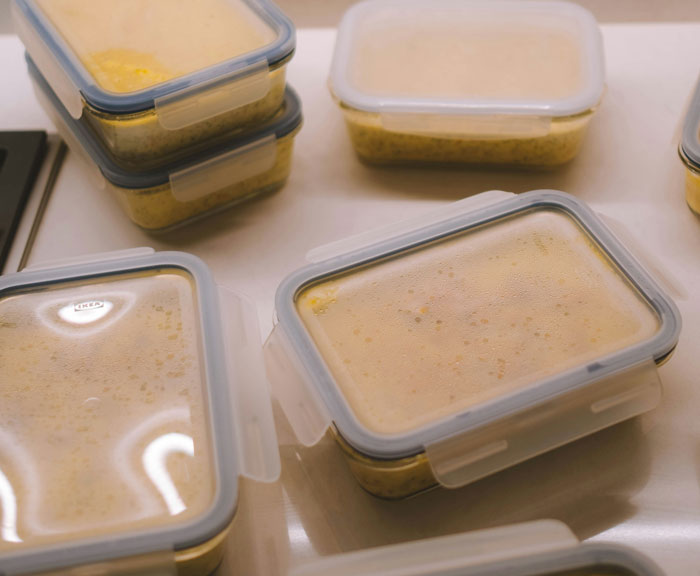 Containers filled with lazy meals stacked neatly on a countertop.