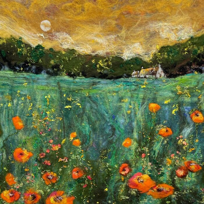 Fiber art landscape by Moy Mackay depicting a vibrant meadow with a house under a dramatic sky.