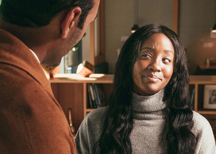 Two people having a heartfelt conversation in a cozy room after coming out of the closet.