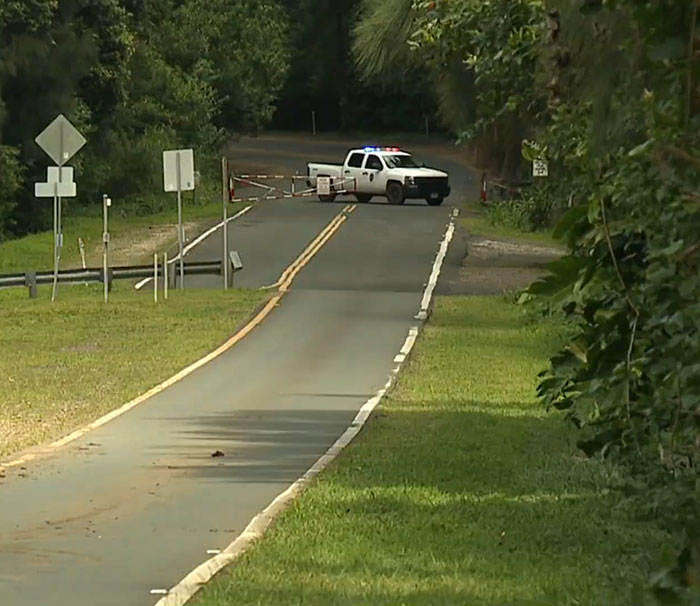 Police vehicle blocks road near Hawaii beauty spot in alleged homicide case. Police vehicle blocks road near Hawaii beauty spot in alleged homicide case.