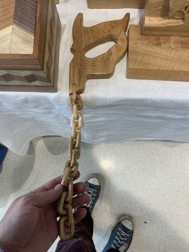 Strange thrift find: wooden chain with a decorative handle on display.