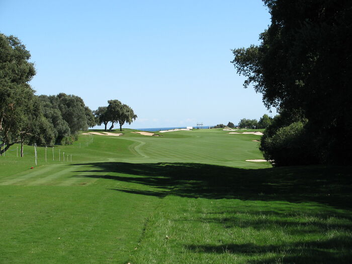 Breathtaking golf course with lush green fairways and distant ocean views.