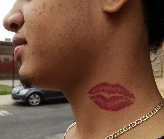 Side profile showing a lip print tattoo on a person's neck, linked to perceptions of unattractive tattoos.