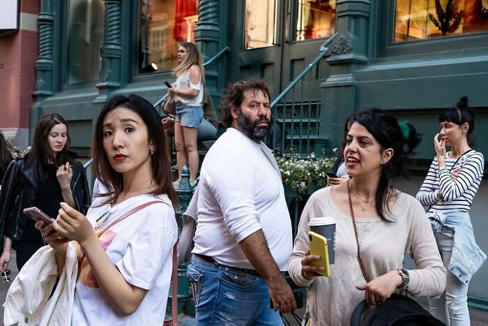People captured at a perfectly timed moment on a busy street, showcasing unexpected expressions and interactions.