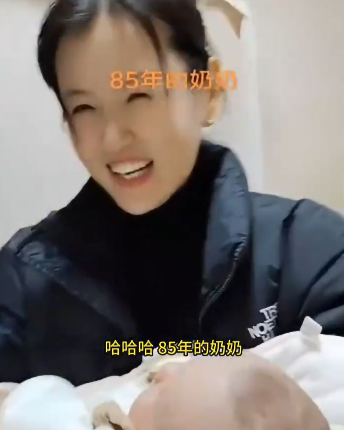 A young-looking grandmother smiling while holding a baby, highlighting three generations. A young-looking grandmother smiling while holding a baby, highlighting three generations.