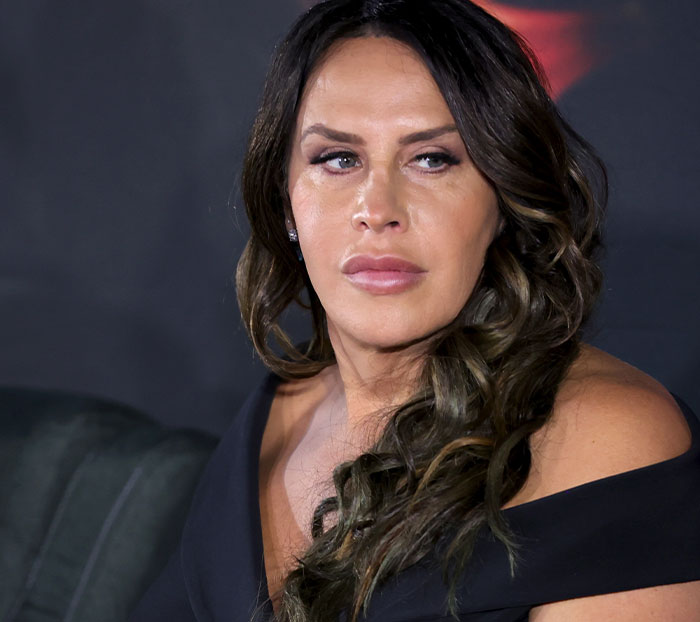 Person in a black outfit at an awards show, embodying one of many scandalous moments in entertainment events.