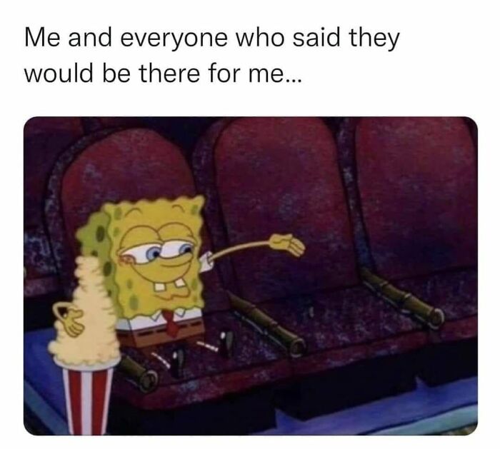 SpongeBob sitting alone in empty theater seats with popcorn; evokes nostalgia for old cartoons.