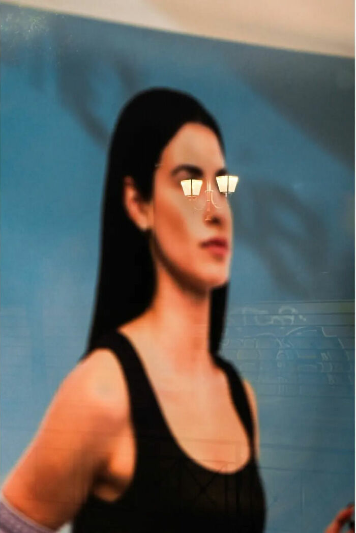 Street life artistry reflected in a portrait with lamp post eyes.