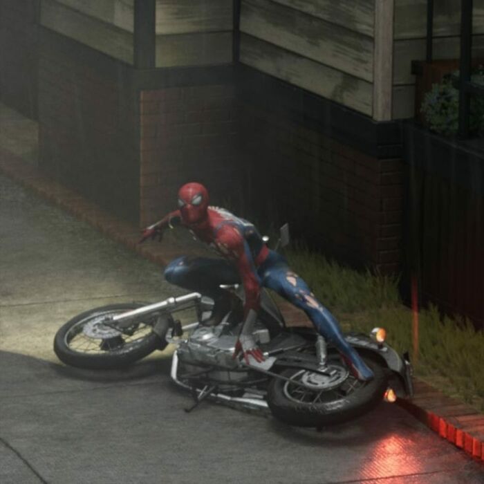 Spider-Man humorously posed on a fallen motorcycle in an alley, blending superhero flair with random funny moments.
