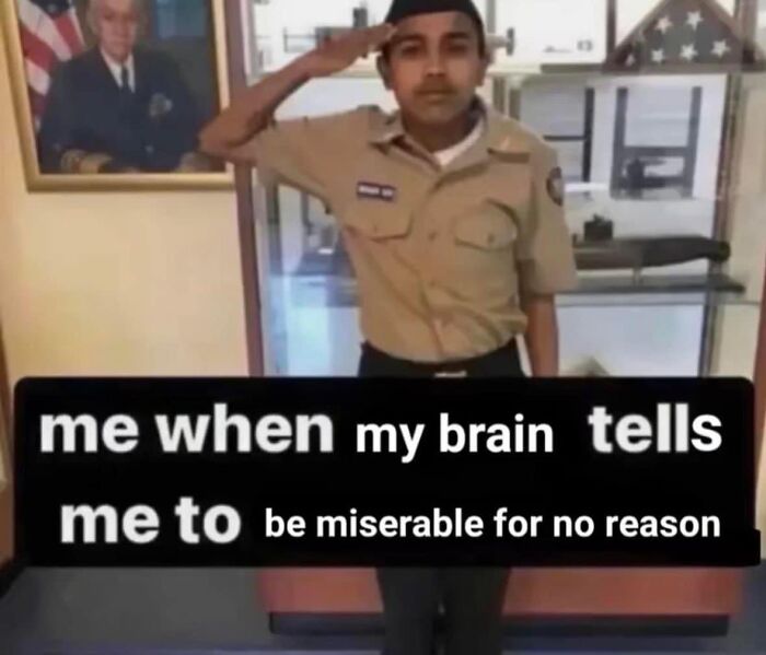 Young man saluting humorously in a meme, with text about being miserable for no reason; funny memes for a chuckle.
