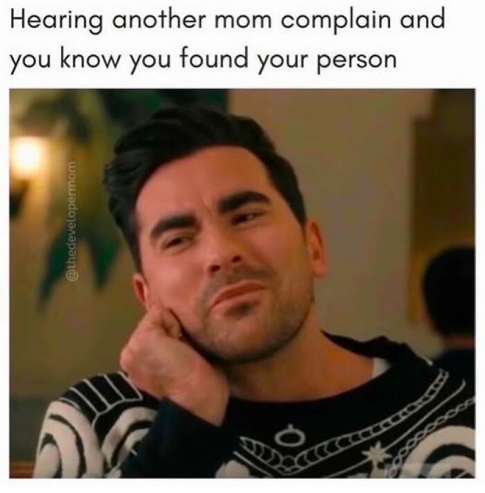 Man listening with a knowing expression, relatable parenting meme humor about finding connection through shared mom complaints.
