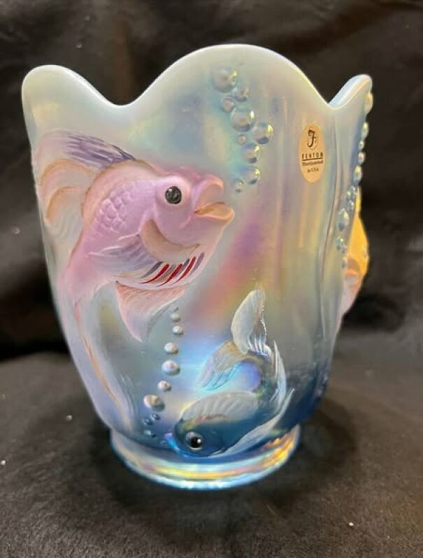 Iridescent thrifted vase with embossed fish design and a wavy rim.