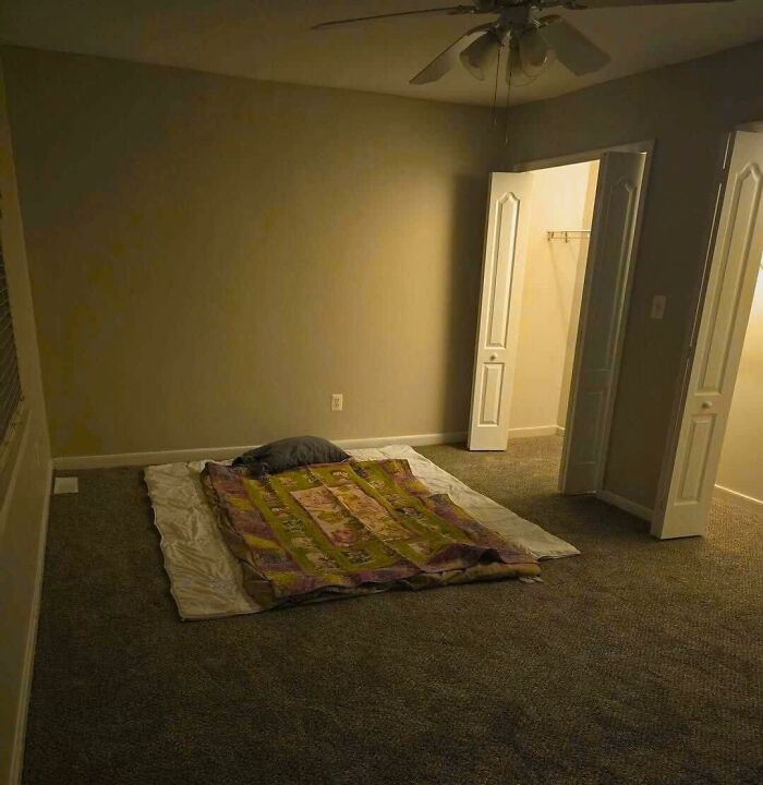 An empty room with a mattress on the floor, adding a touch of random humor.