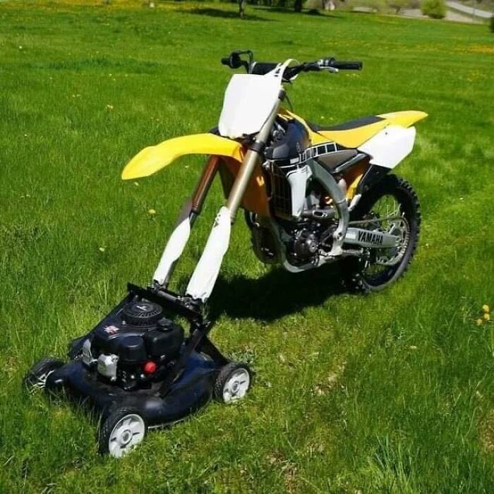 Funny image of a motorcycle fused with a lawn mower on green grass.