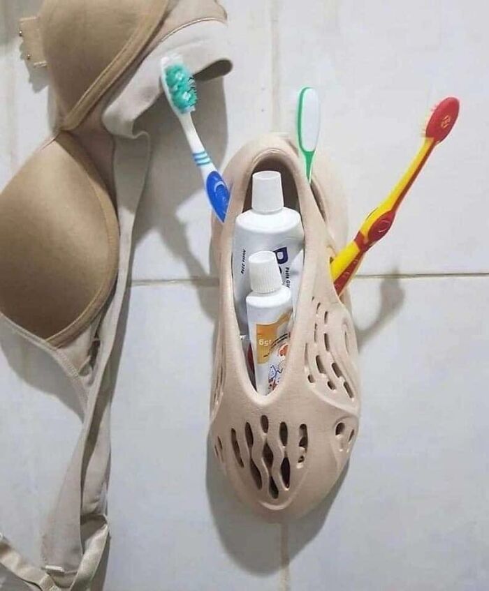 Random photo: a bra and shoe used as creative storage, holding toothbrushes and toothpaste.