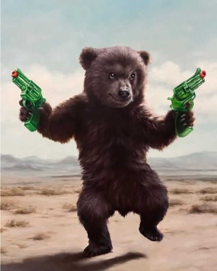 A bear with toy guns, showcasing anthropomorphic artwork by Richard Ahnert in a desert setting.