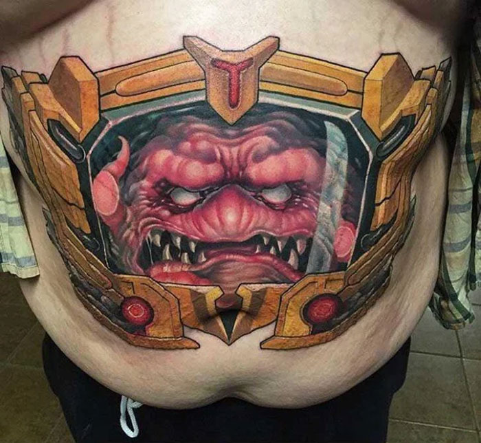 Tattoo of a monstrous face on stomach, illustrating unattractive tattoo choices.
