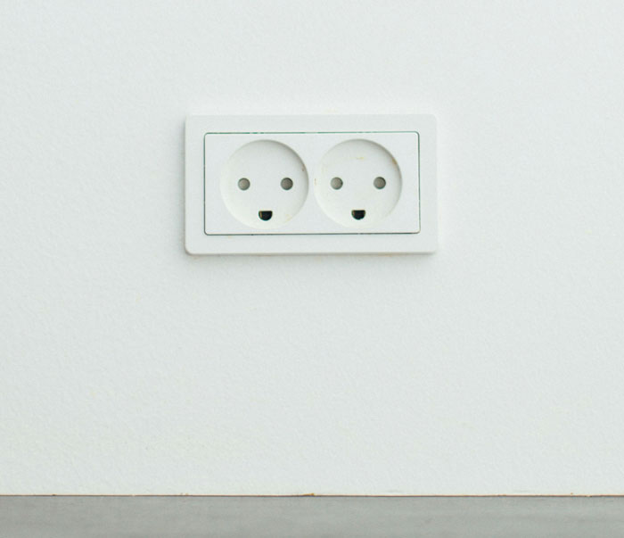 Wall outlet, a hidden spot at home for storing small items discreetly.