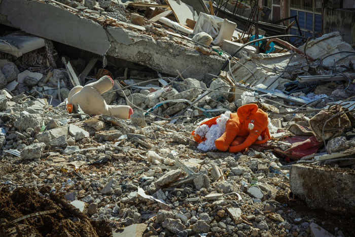 Rubble of a collapsed building with scattered debris, highlighting safety awareness for life-saving situations.