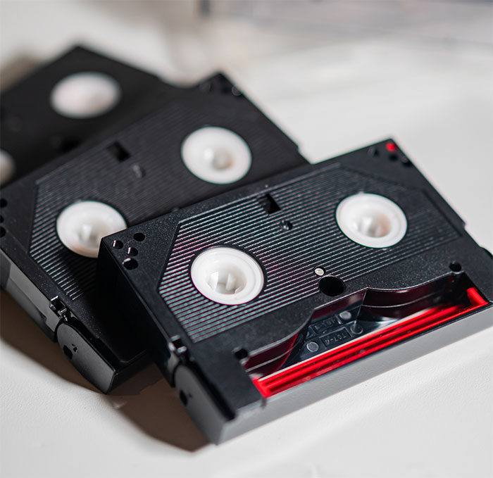 Cassette tapes on a table, symbolizing a father's plan to surprise his daughter with recordings of her late mother.