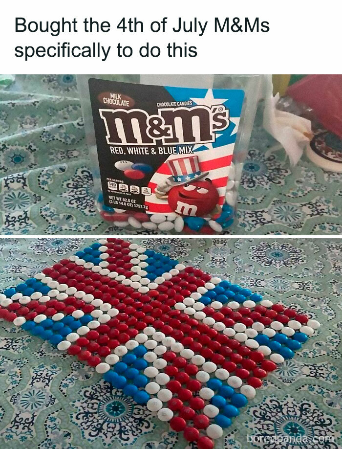 M&M's in red, white, and blue arranged to create a flag pattern on a patterned tablecloth.