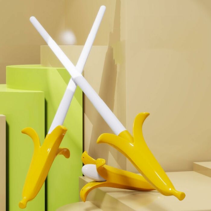 Two toy banana swords crossed creatively on a whimsical yellow and green backdrop, showcasing fun Amazon finds.