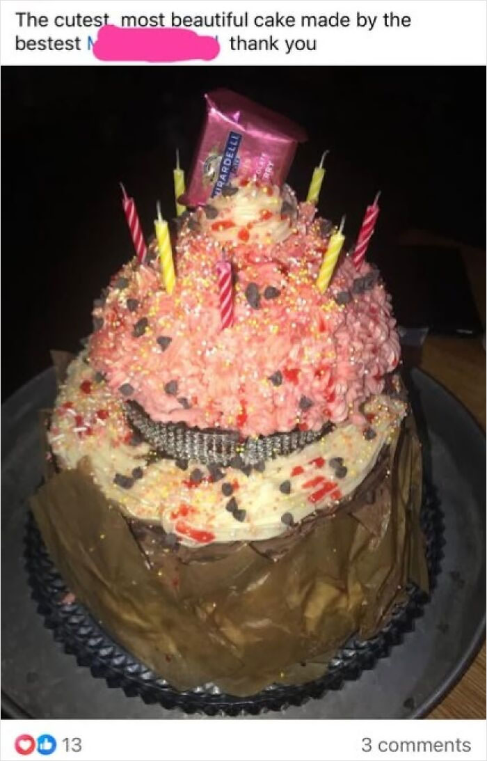 Colorful layered cake topped with candles and chocolate, showcasing a funny baking fail.