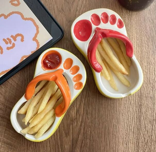 Ceramic sandal trays shaped like feet holding fries and ketchup, a strange thrifting find.