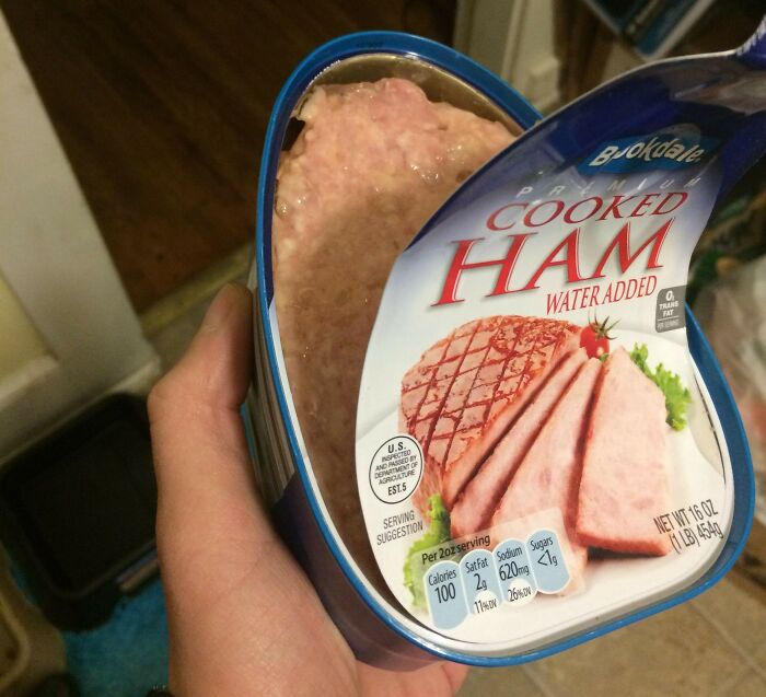 Opened can of cooked ham, showcasing contents differing from the label. Mess-around-find-out moment captured in a kitchen setting.
