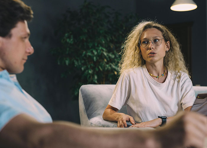 Two colleagues in a serious discussion, highlighting potential toxic workplace dynamics.