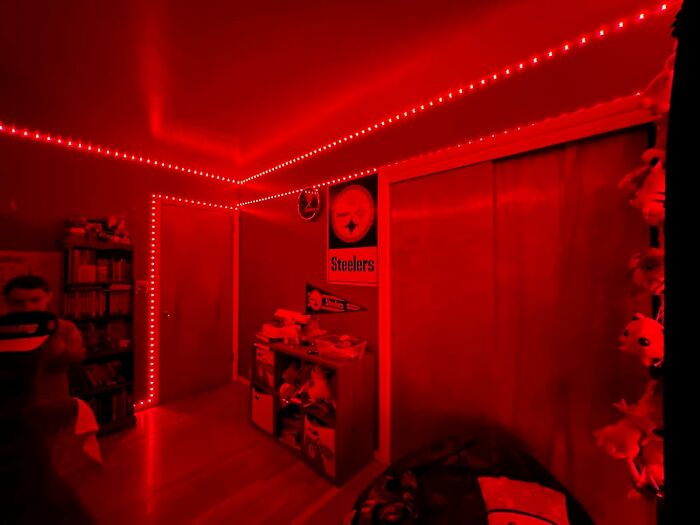 Room lit by red LED lights, Steelers decor, exemplifying bargain discounts.