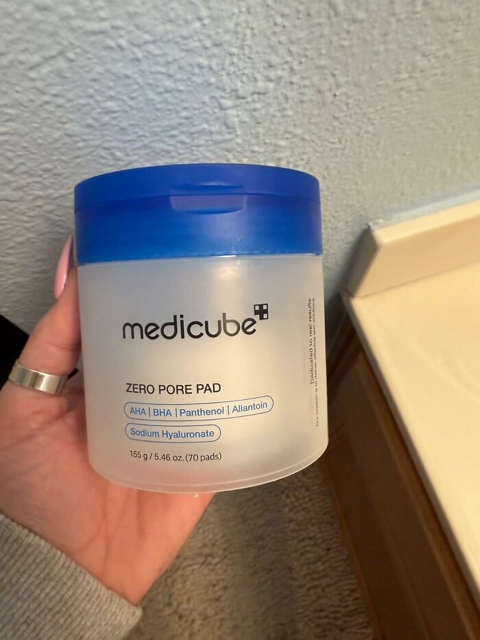 Medicube Zero Pore Pad container held in hand, offering spring discounts on Amazon.