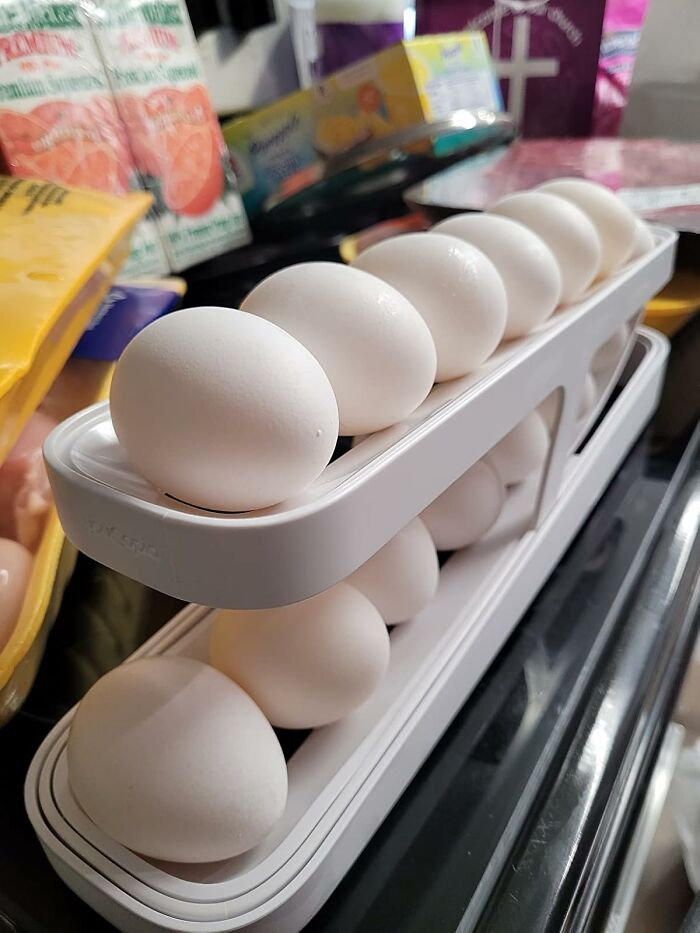 Eggs neatly organized in a white plastic holder, showcasing efficient kitchen storage tools.