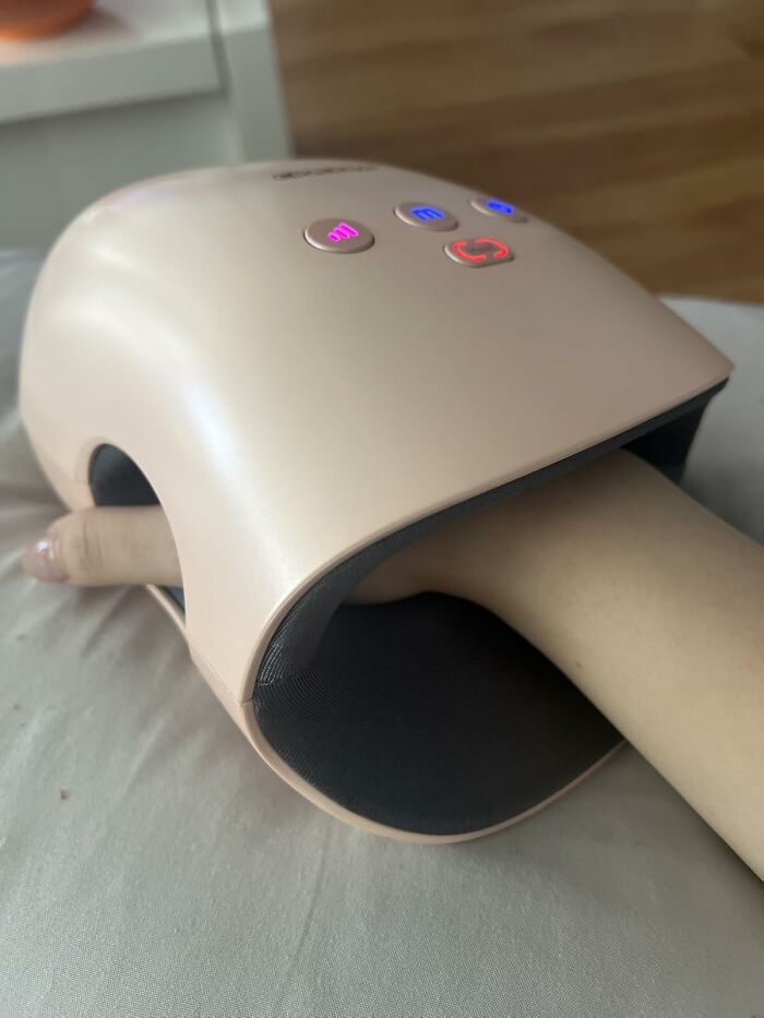 Hand inside an electronic nail dryer, illustrating a tool for unexpected job tasks.