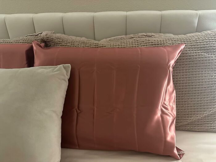 Silk pillowcase on a bed, great for curls care and reducing hair frizz.