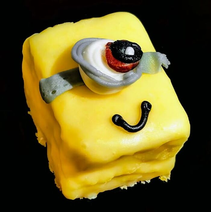 Funny baking fail featuring a yellow cake with a whimsical, cartoonish design.