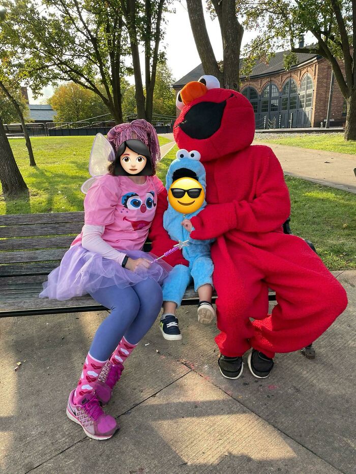 Dads bonding dressed in fun costumes with kids at a park, showcasing the rewarding job of being a father.