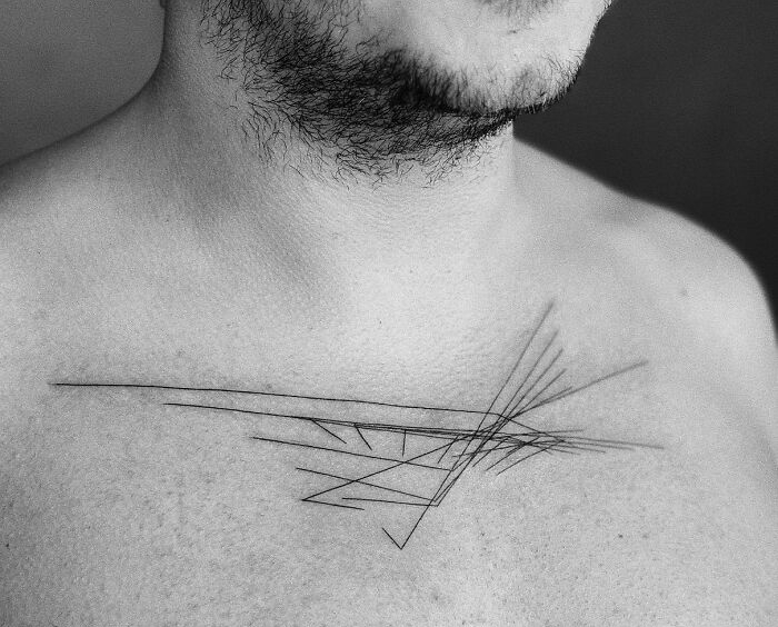 Abstract tattoo on chest depicting unique brain activity imprint with geometric lines.