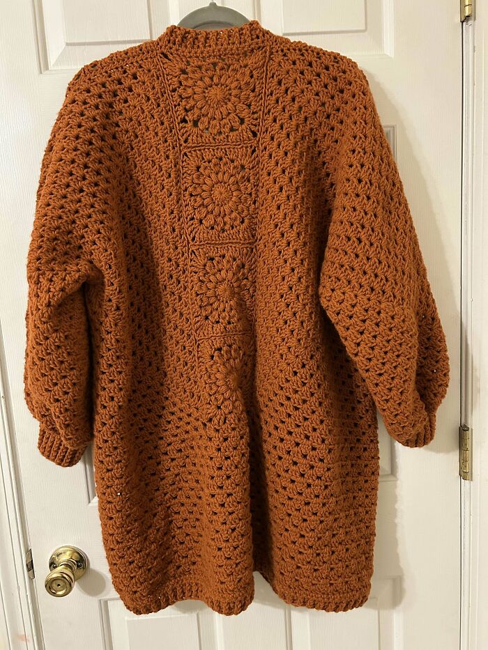 Handmade crochet cardigan in brown with intricate floral patterns, showcasing incredible crochet craftsmanship by enthusiasts.