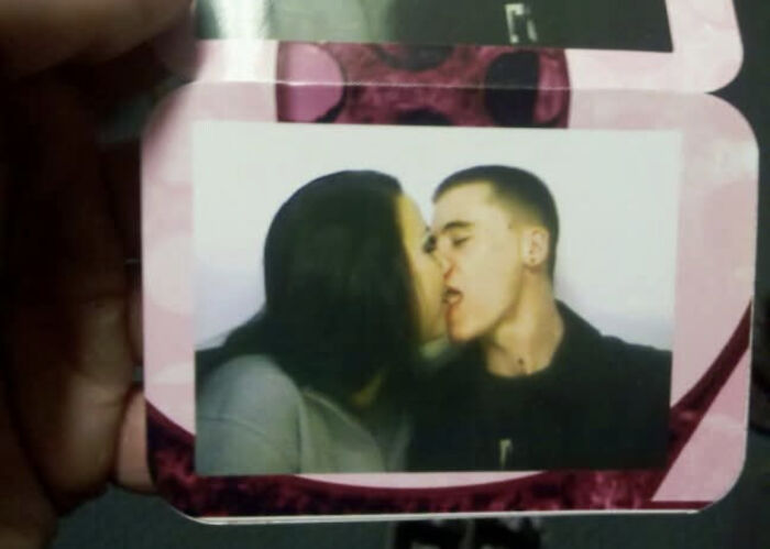 Photo of a young couple awkwardly kissing in a nostalgic picture from people’s regrettable past moments.