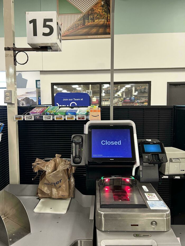 Self-checkout with a "Closed" screen and a bag left behind, illustrating customer cluelessness.