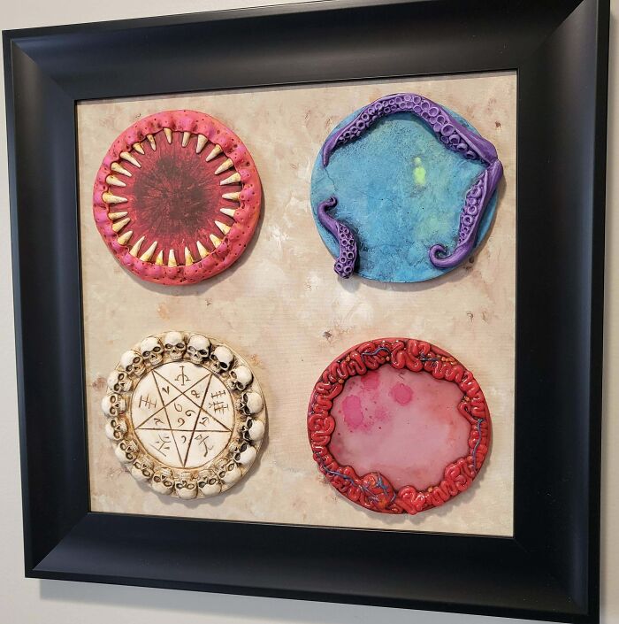 Four unique, creepy handmade crafts framed on a wall, featuring unusual and intricate designs with artistic flair.