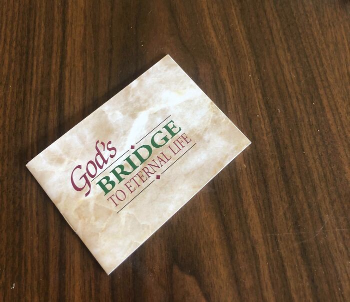 Brochure titled "God's Bridge to Eternal Life" on a wooden table, related to mildly infuriating server tips.