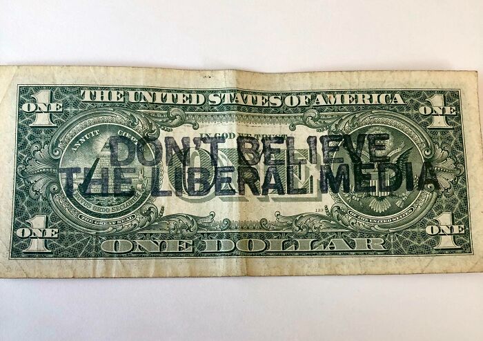 Dollar bill with "Don't believe the liberal media" printed over it, exemplifying mildly infuriating server tips.
