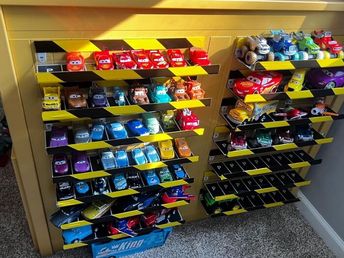 Colorful toy cars neatly organized on shelves, showcasing effective storage for sentimental clutter.