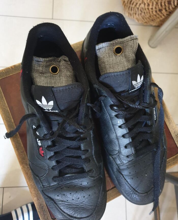 Black sneakers with brand logos, suggesting they'd be better delivered in a plain brown box for discreetness.