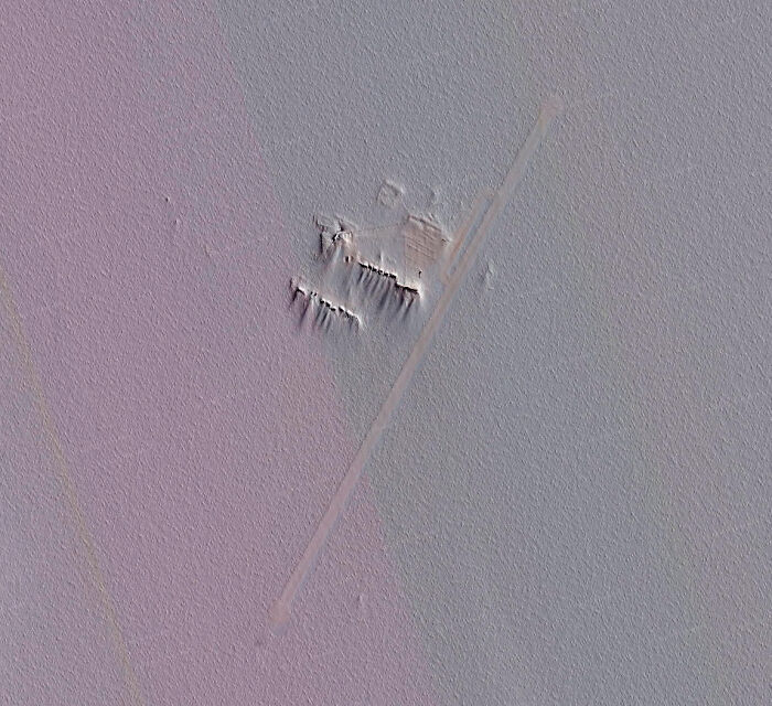 Aerial view of a strange structure found using Google Earth, resembling an abandoned airstrip in a desolate landscape.
