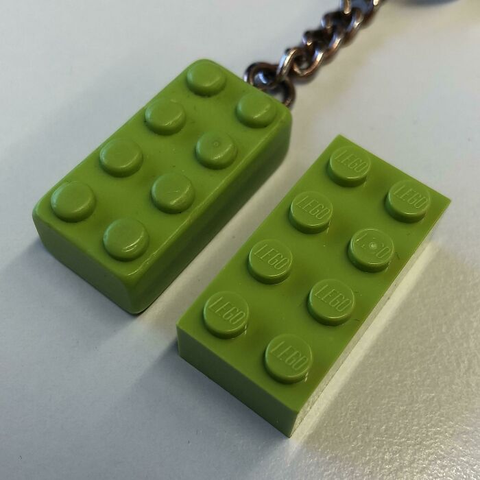 Green LEGO bricks showing signs of use over time, one attached to a keychain.
