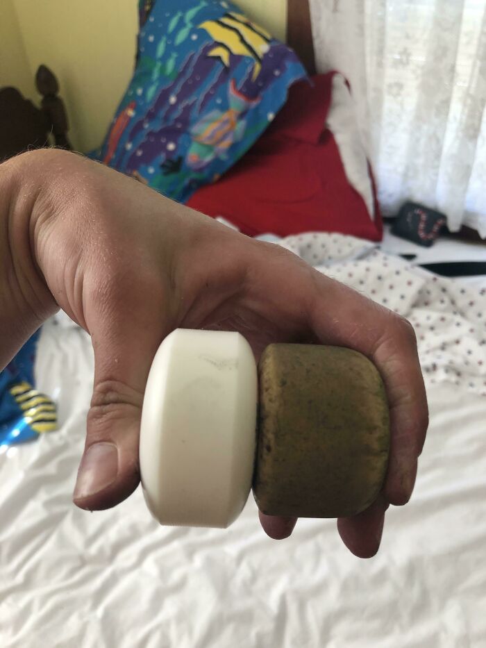 Hand holding a new and used skateboard wheel side by side, illustrating things used over time.